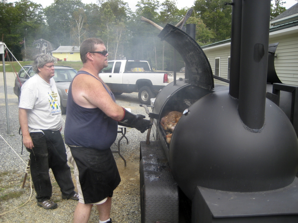 Men work the smoker at a previous Beast Feast.