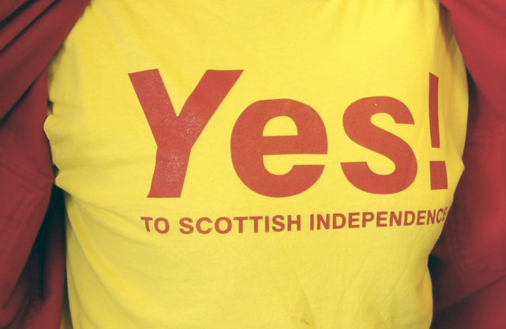 Bill McKeen shows off the T-shirt he made saying yes to Scottish independence during an interview on Tuesday at Minuteman Signs in Augusta.