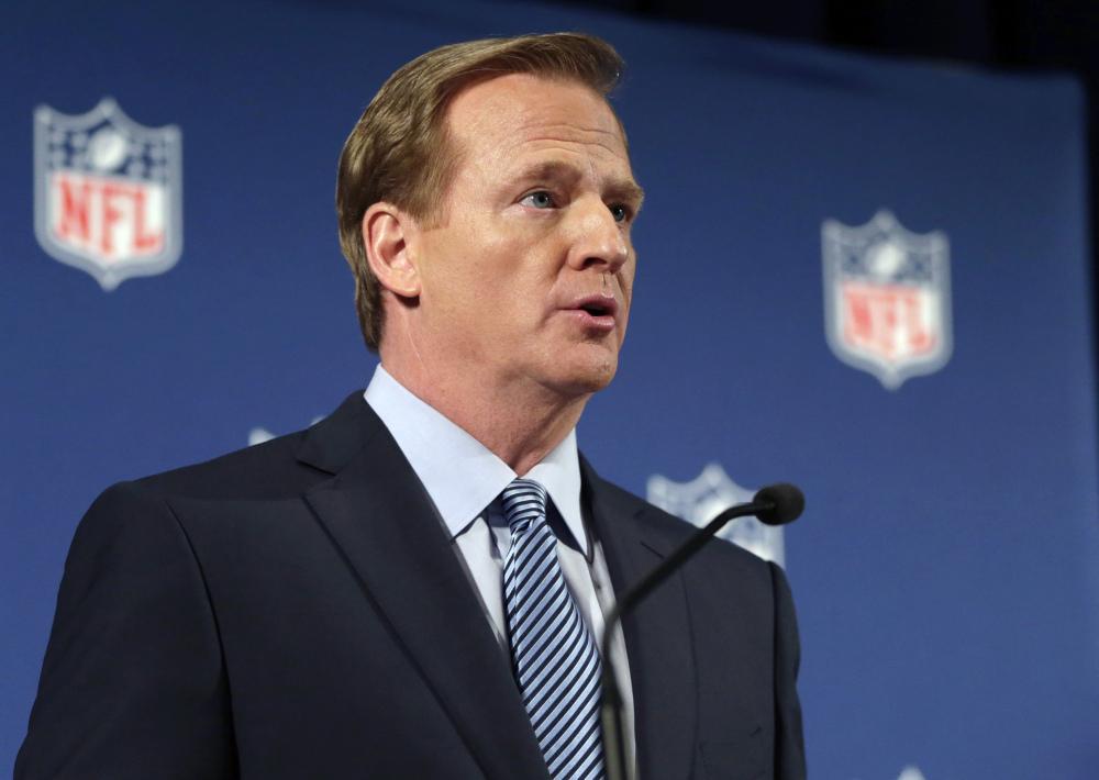 NFL Commissioner Roger Goodell, seen speaking at a news conference Friday in New York, says the NFL wants to adopt new personal conduct policies by the Super Bowl. The league has faced increasing criticism that it has not acted quickly or emphatically enough in response to domestic abuse cases.