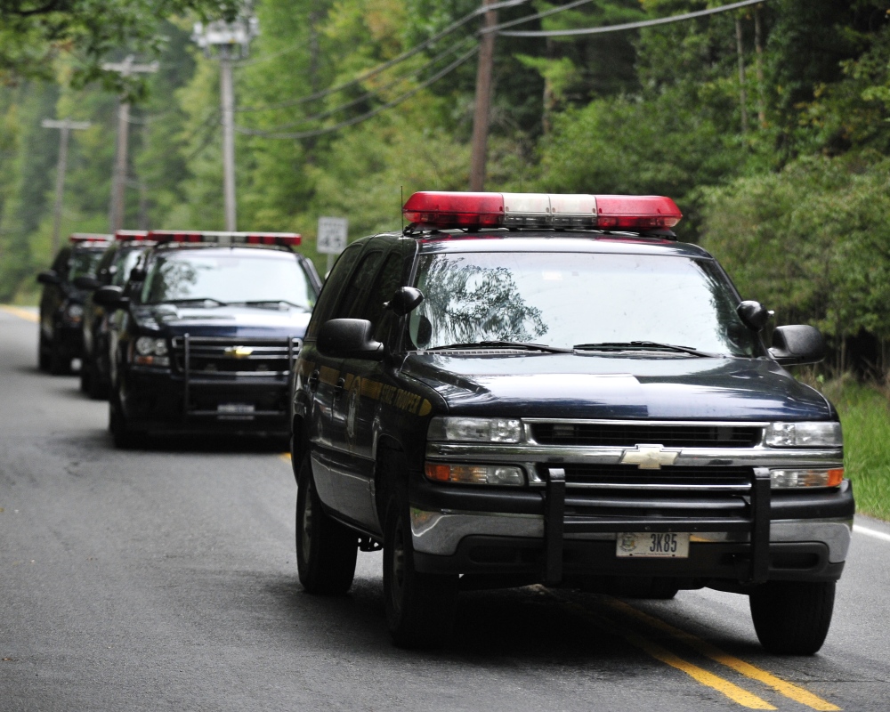 Police surround a neighborhood in the Pocono Mountains in search of suspect Eric Frein on Saturday in Canandensis, Pa. Police have charged Frein with opening fire outside a state police barracks in northeastern Pennsylvania on Sept. 12. Cpl. Bryon Dickson was killed and Trooper Alex Douglass was wounded by the gunman with a high-powered rifle.