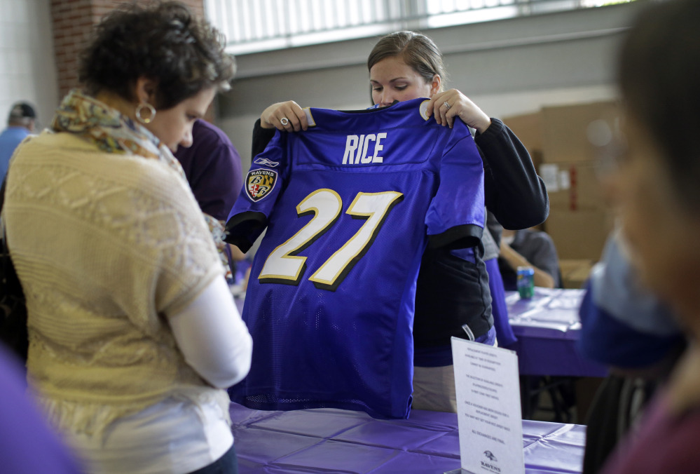 A worker folds up a former Baltimore Ravens running back Ray Rice jersey that a fan traded in on Friday at M&T Bank Stadium in Baltimore. The Ravens offered fans a chance to exchange their Rice jerseys for those of another player after he was cut by the team and suspended indefinitely by the NFL for domestic violence.
