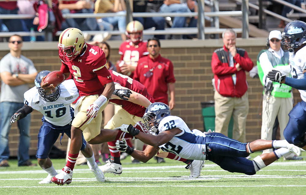 Boston College quarterback Tyler Murphy breaks away from Maine’s Randy Samuels to start a touchdown run in the first quarter Saturday in Boston.