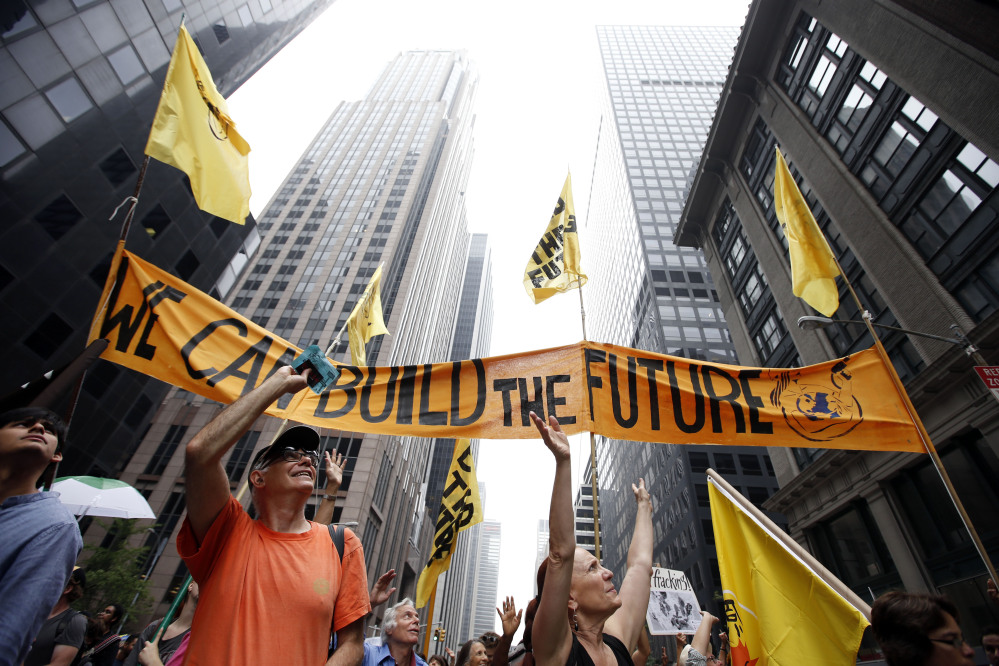 Demonstrators make their way down Sixth Avenue during the People’s Climate March  in New York on Sunday.
