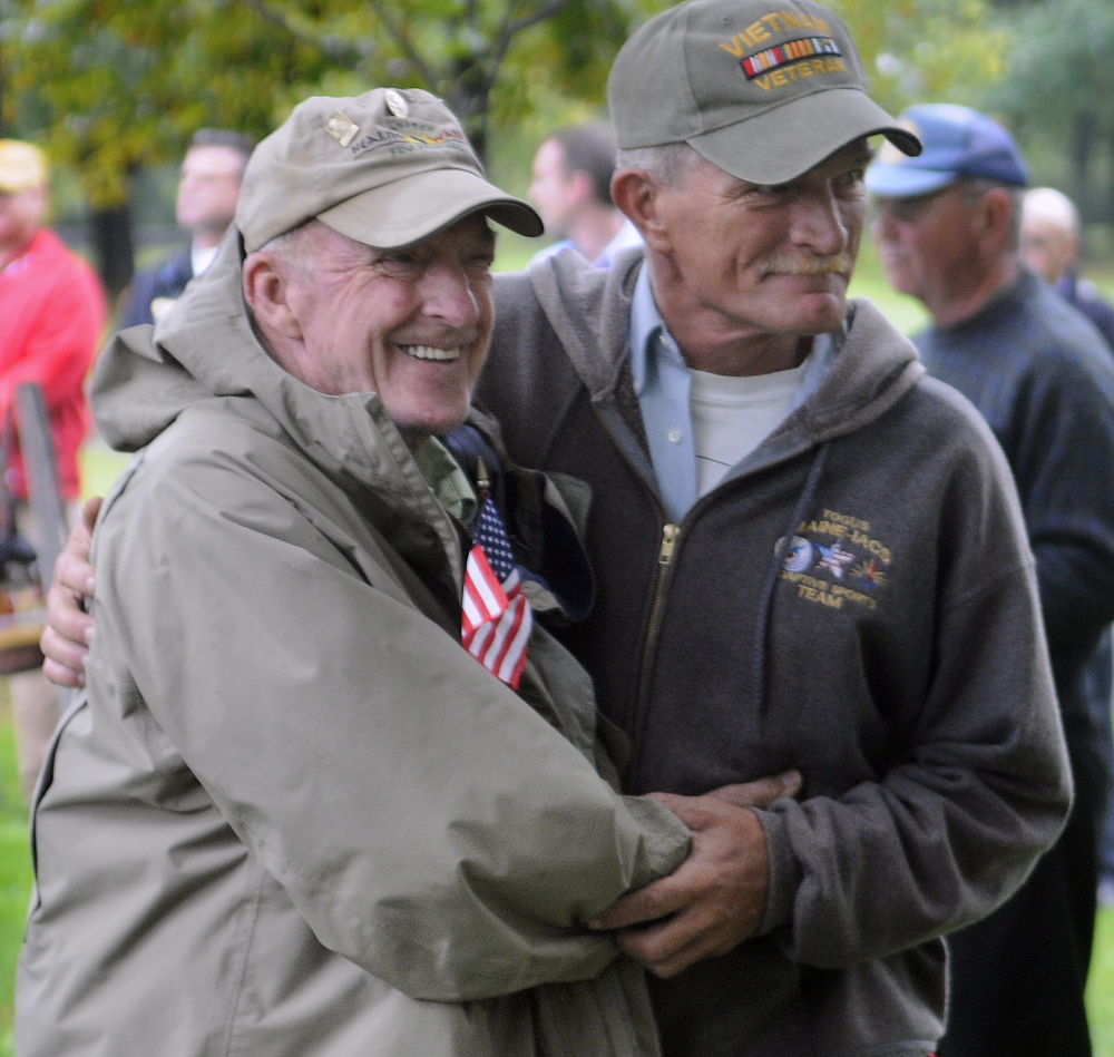 Vietnam veteran David Nevedomsky of Winslow, right, greets fellow veteran Don Taylor of Mount Vernon Sunday during a ceremony in Capitol Park in Augusta to honor Vietnam vets.