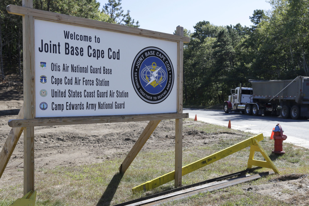 A truck drives past a welcome sign to Joint Base Cape Cod, Monday, in Sandwich, Mass.