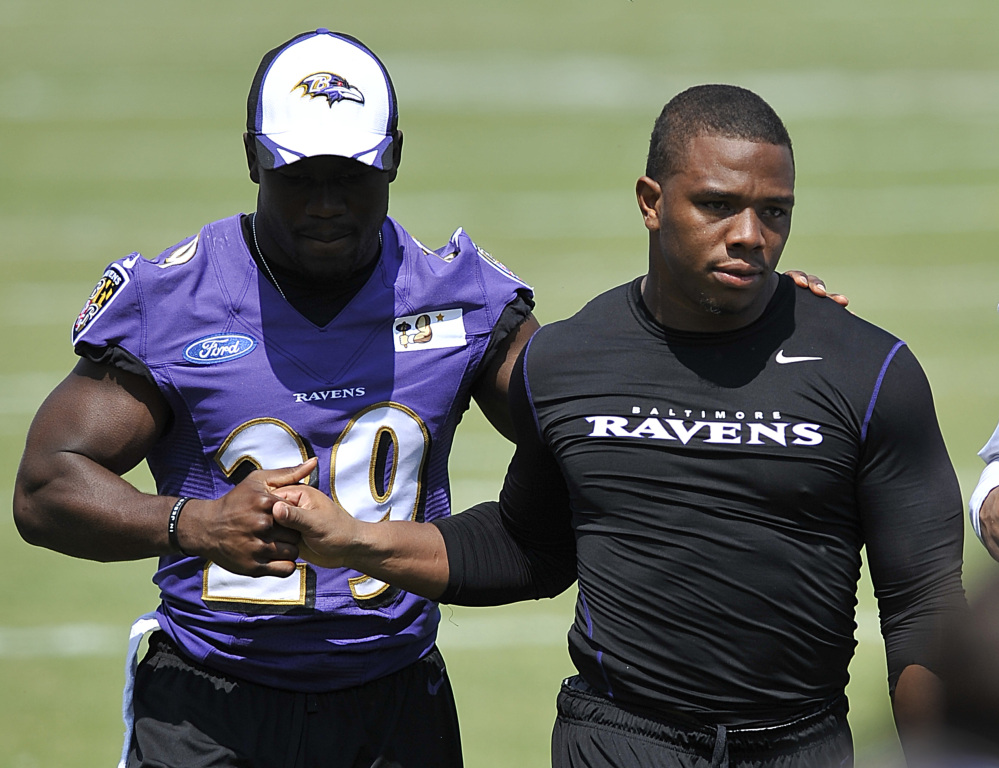 Baltimore Ravens running back Ray Rice, right, shown walking off the field with Justin Forsett in July, was caught on video hitting his then fiancee.
