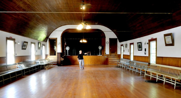 Kathleen Perelka, president of the Canaan Farmers Hall, walks through the dance hall portion of the former Canaan Grange on Monday. A fundraiser raffle will be held this Sunday for 1.28 acres of land, and the proceeds will be used to install an elevator.