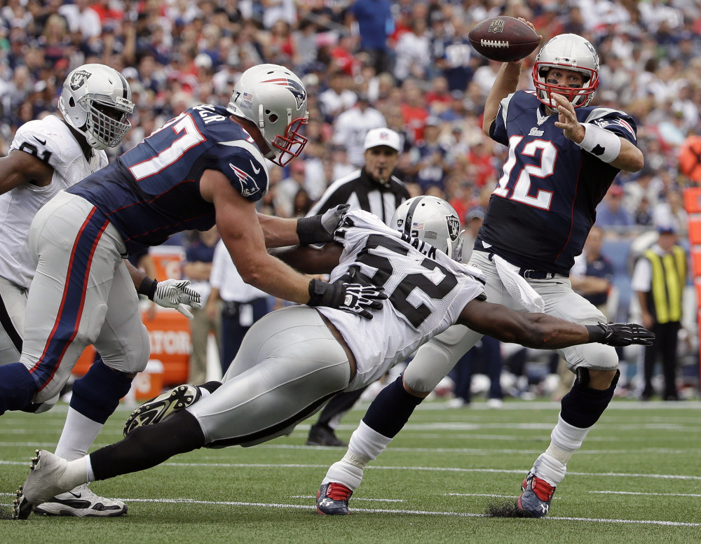 Oakland Raiders outside linebacker Khalil Mack (52) pressures New England Patriots quarterback Tom Brady in the first half Sunday in Foxborough, Mass. The Patriots won 16-9.