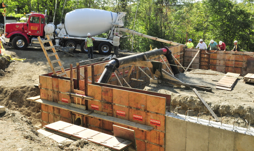 Workers pour the concrete foundation for the new water treatment building being constructed at the Greater Augusta Utilities District’s new east side well complex off Riverside Drive in Augusta.