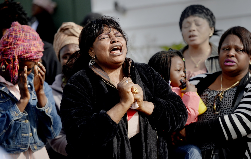 adfs;ljkl;kj ..... LEWISTON, ME - SEPTEMBER 25: Ana Mavungo sings during a memorial for her friend Laudrinha Kubeloso, who was struck and killed by a hit-and-run vehicle Tuesday. Friends and neighbors gathered at Howe Street Thursday, September 25, 2014. (Photo by Shawn Patrick Ouellette/Staff Photographer)