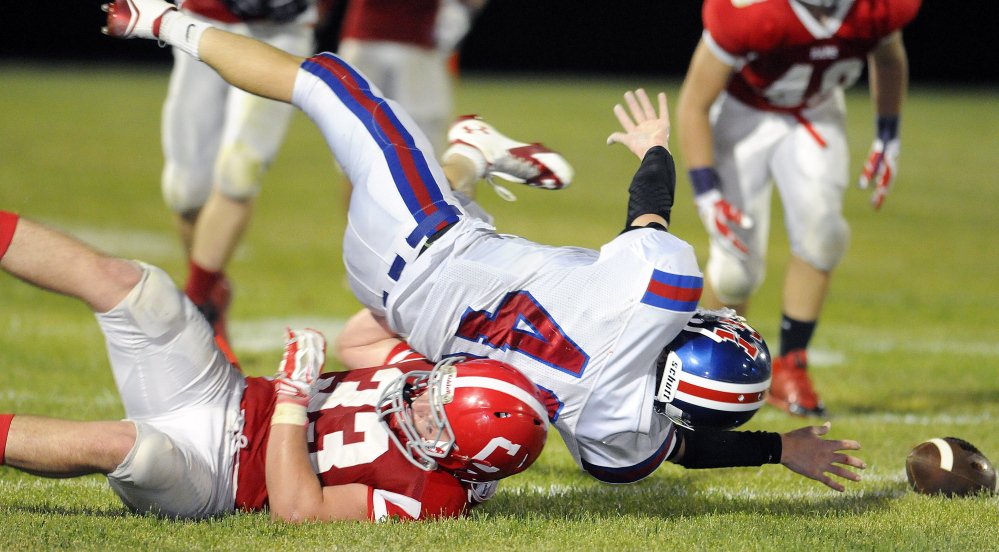 Staff file photo by Andy Molloy
 Cony linebacker Reid Shostak (33), hauls down a Messalonskee running back Caleb Chavarie during a Pine tree Conference Class B game earlier this season. Shostak and Rams venture to Keyes Field tonight for a game against Lawrence.