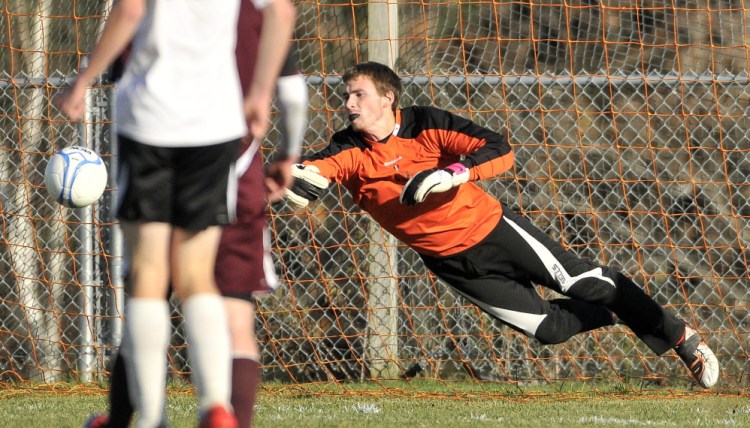 Winslow High School goalie Alex Berard dives to try and stop a shot during a game against Foxcroft last year. Berard, a senior, had a 10-game shutout streak last season for the Black Raiders.