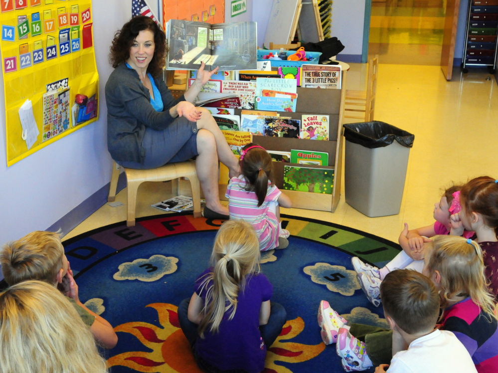 Susanne Murphy reads a book to a group of her 4-year old students on Friday in the Learning Center at the Kennebec Valley YMCA in Augusta. The YMCA and Lithgow PUblic Library are teaming up on a fundraiser that will benefit both organizations.
