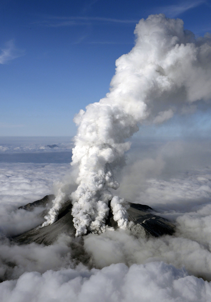 Dense white plumes are spewed out from Mt. Ontake as the volcanic mountain erupts in central Japan on Saturday. With a sound likened to thunder, the 10,062-foot mountain spewed large white plumes high into the sky, sending people fleeing, covering surrounding areas in ash and trapping more than 250 climbers.