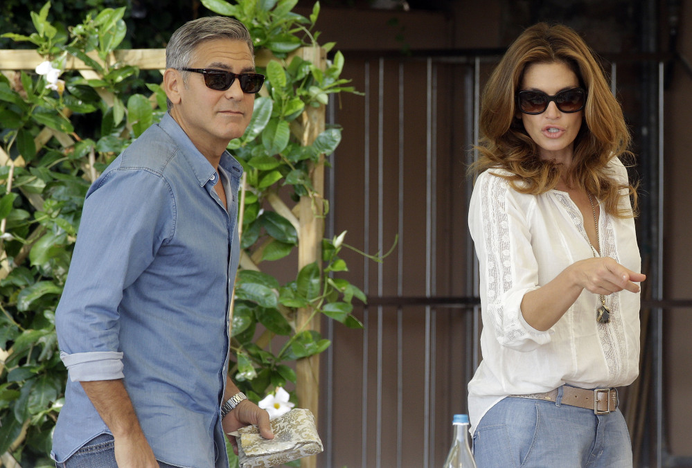 George Clooney and Cindy Crawford walk in the garden of the Cipriani hotel in Venice on Saturday. Clooney, 53, and Alamuddin, 36, are expected to get married this weekend in Venice, one of the world’s most romantic settings.