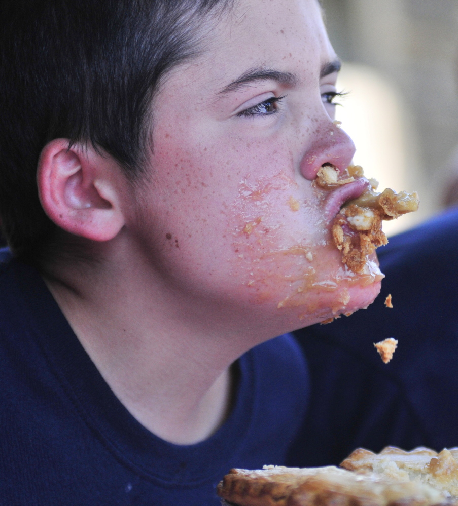 Ethan Larabee, 14, of Monmouth, competes in the apple pie eating contest on Saturday during the Monmouth Apple Festival.