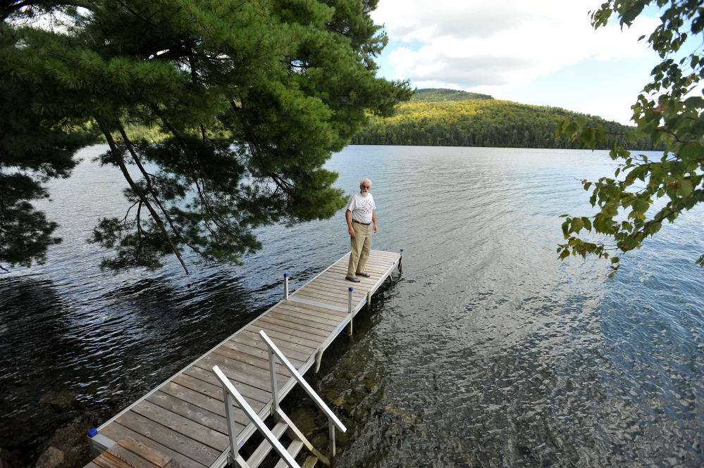 Craig Dickstein, of The Forks, stands on the dock of his home which is divided by the town line of Caratunk and The Forks. Dickstein is part of an effort for Pleasant Pond to secede from The Forks and become part of Caratunk.