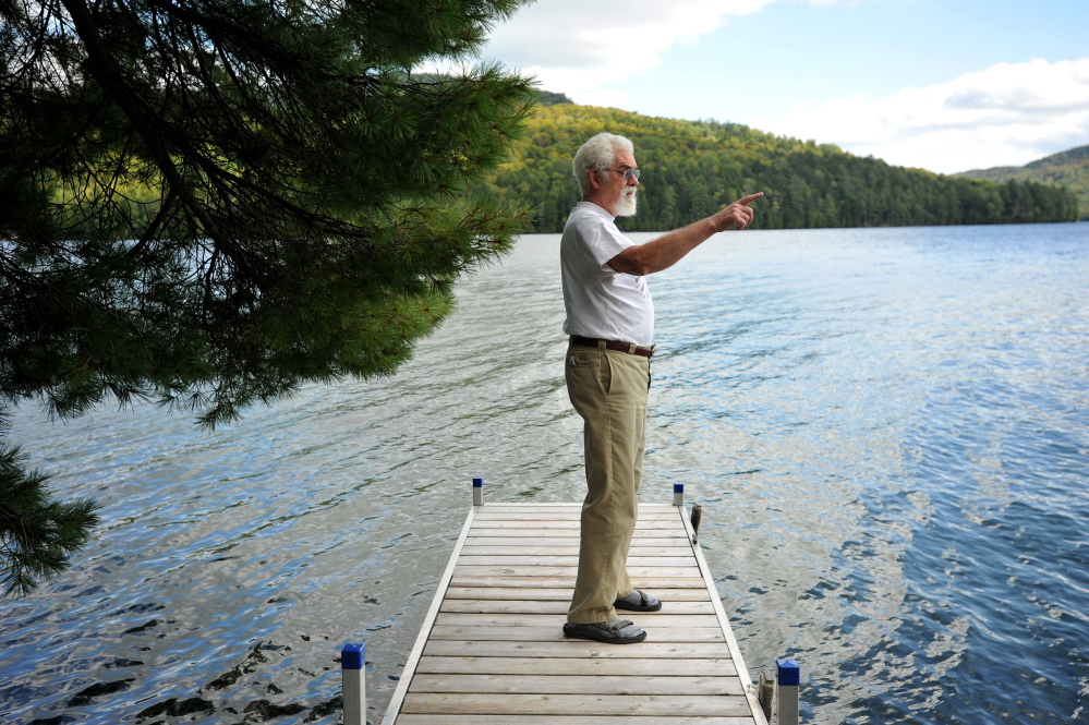Craig Dickstein, of The Forks, stands on the dock of his home which is divided by the town line of Caratunk and The Forks. Dickstein is part of an effort for Pleasant Pond to secede from The Forks and become part of Caratunk.