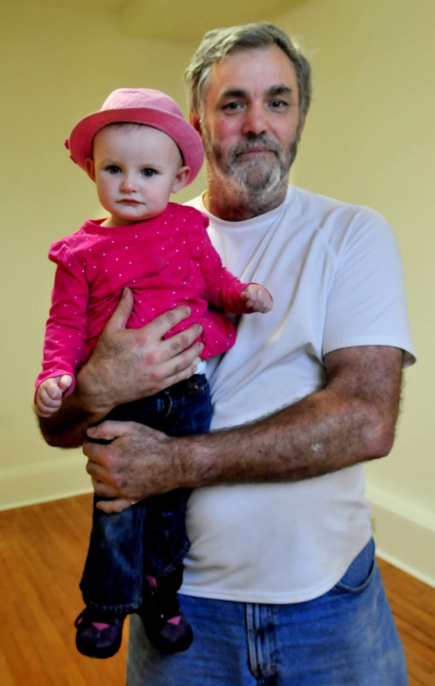 Land raffle winner Orrin Fitzgerald holds 18-month-old Amelia Brown who picked the winner in the Canaan Farmer’s Hall raffle to raise money for an elevator. Fitzgerald won a 1.28-acre plot of land on Hinckley Road.