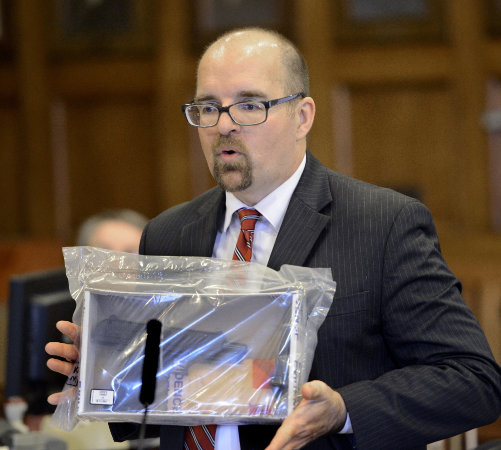 Assistant Attorney General Donald Macomber shows the jury the murder weapon during opening statements in the murder trial of Anthony Pratt Jr. at the Cumberland County Court House in Portland.