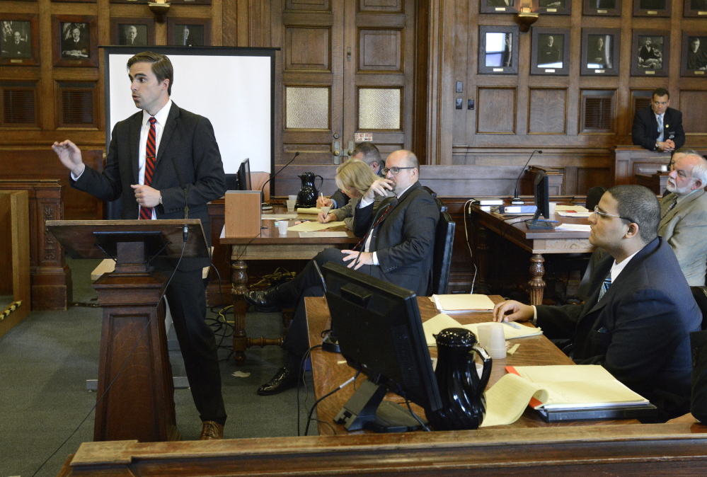 Defense attorney Dylan Boyd makes his opening statement to the jury in the murder trial of Anthony Pratt Jr. (seated lower right) at the Cumberland County Court House in Portland. Assistant Attorney General Donald Macomber listens in background.