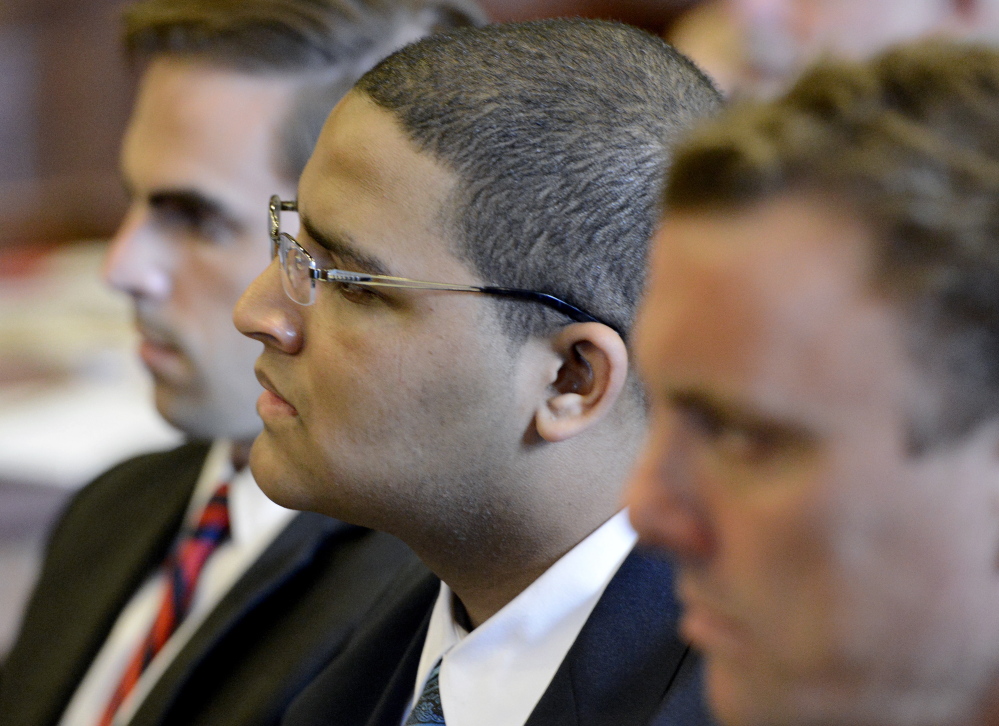 Anthony Pratt Jr., center, is flanked by his attorneys Dylan Boyd, left, and Peter Cyr as they listen to opening statements by the prosecution in the murder trial of Pratt at the Cumberland County Court House in Portland on Monday.