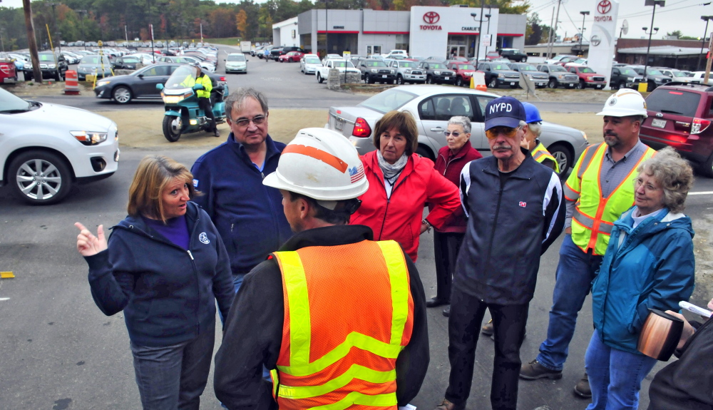 Mary Lou Lane, far left, and other Smith Street residents meet with Maine Department of Transportation engineer Seth Wills, center, on Tuesday at the corner of Smith Street and Western Avenue in Augusta. Residents expressed concern about not being able to see approaching traffic when they pull out of Smith Street onto Western Avenue.