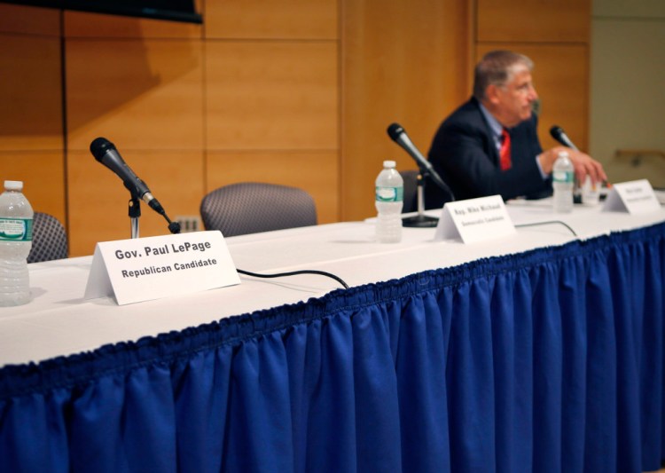 A seat at a table reserved for Gov. Paul LePage remains vacant after the governor decided to pull out of an energy forum at the University of Southern Maine in Portland on Friday. The Associated Press / Robert Bukaty