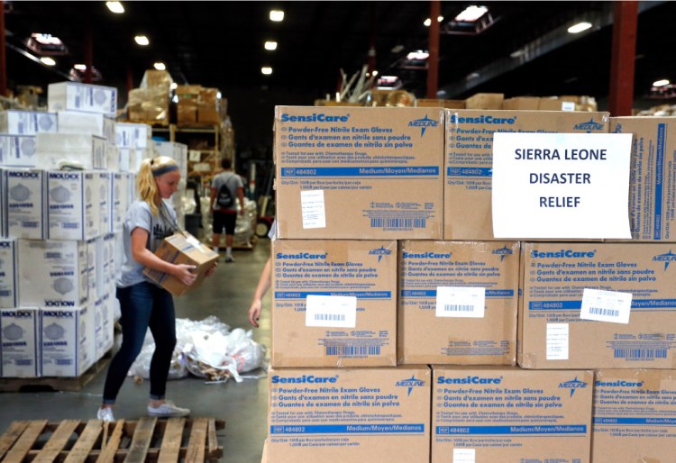 A volunteer in Centennial, Colo., loads a pallet with medical supplies bound for Sierra Leone to combat Ebola. The Associated Press