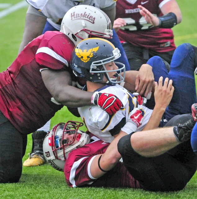 Kents Hill’s Walter Washington, left, and Adam Gigliotti bring down Hyde School’s Toby Taradeina during a game Saturday at Kents Hill School in Kents Hill. The two are postgraduates on the team.