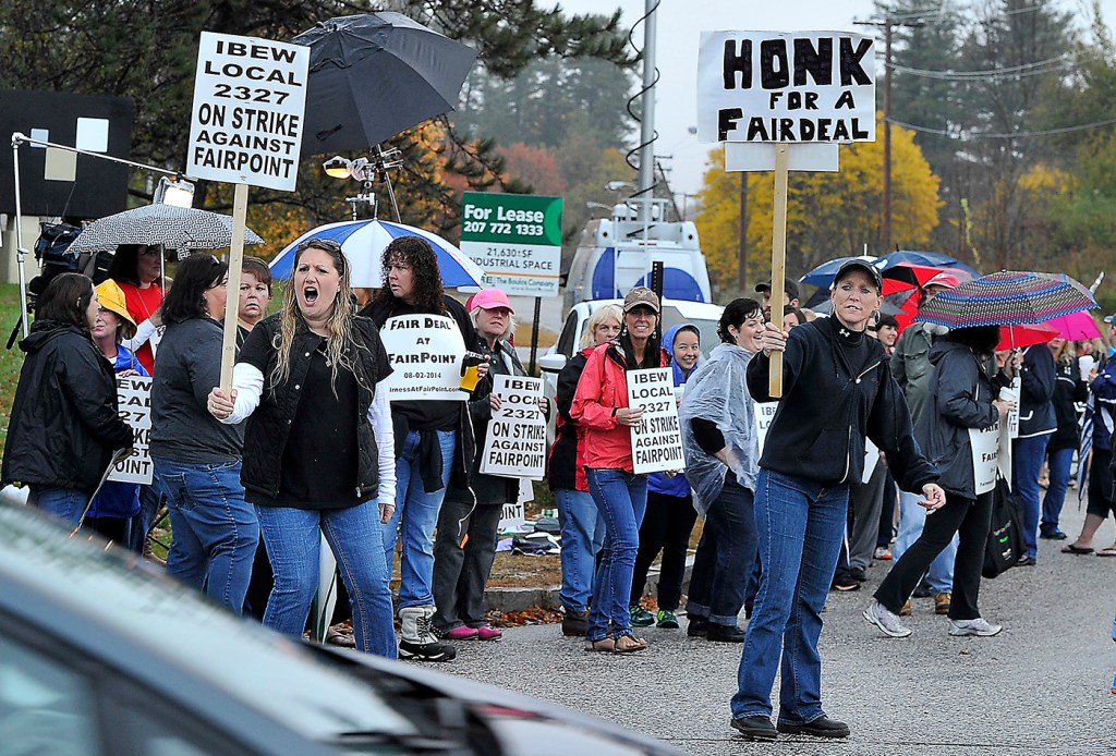 Fairpoint workers on strike march at corner of Davis Farm and Riverside roads after a walkout at midnight from Fairpoint Communicationslocations around Northern New England. (Photo by Gordon Chibroski/Staff Photographer)