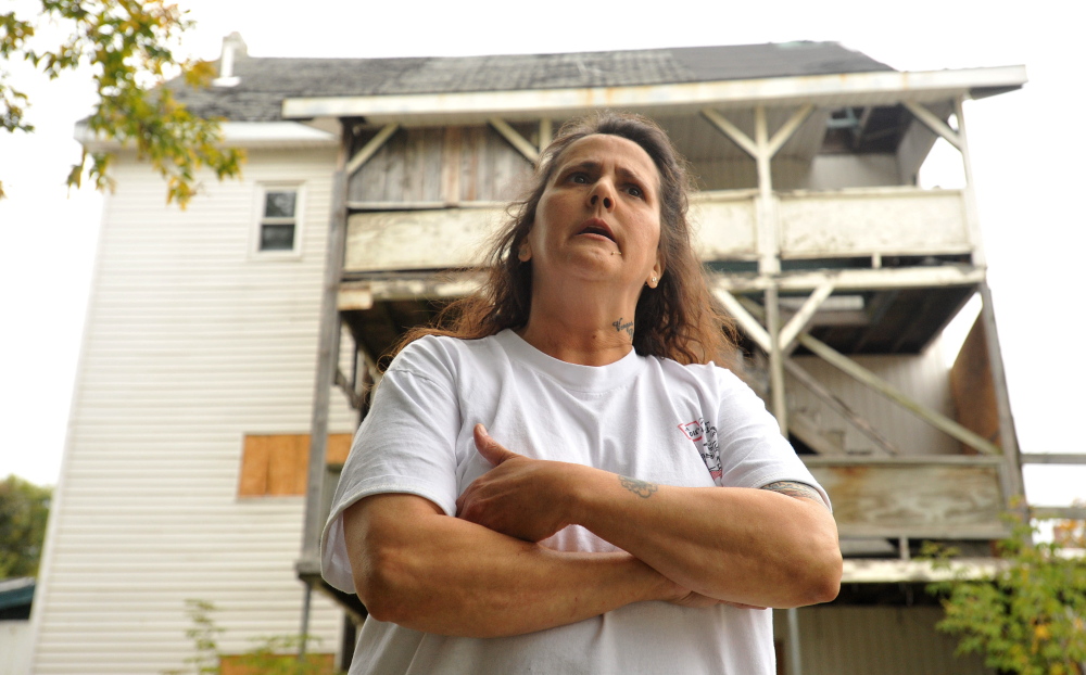 Kerry Vargas, 50, talks about the dangers of living next to the condemned building at 26 Gold St. in Waterville. The city of Waterville is preparing to seize the building and demolish it.