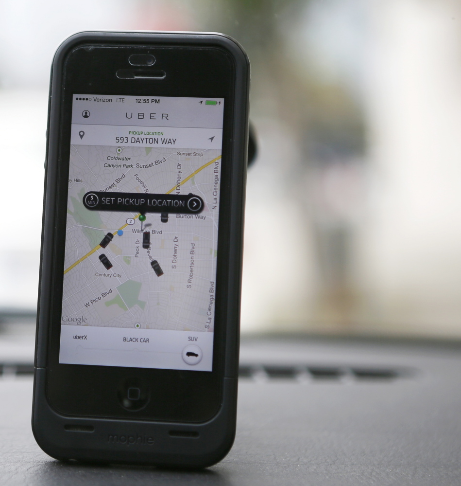 An Uber app is seen on an iPhone in Beverly Hills, Calif. Uber has entered markets in more than 200 cities, ranging from its hometown of San Francisco to Berlin to Tokyo, and arrived in Portland at noon Thursday.