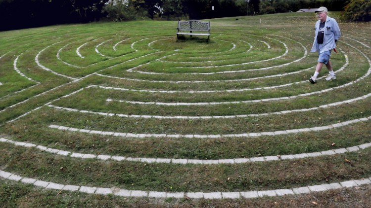Mike Monahan walks the paths of the Labyrinth he created at his home in Farmington where people can be alone to concentrate on their thoughts. “It is  a tool to meditate,” Monahan said.