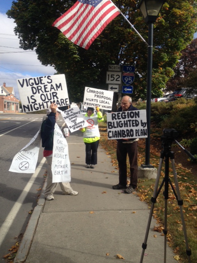 Members of Friends of Piscataquis Valley demonstrate Friday outside the offices of Cianbro Corp. in Pittsfield to protest a proposed East-West Corridor. Cianbro President Peter Vigue has developed a plan for the toll highway connecting Maine to Canada. Protesters say the highway will likely cut through Maine towns, likely including Dover Foxcroft, and destroy the natural beauty of the state.