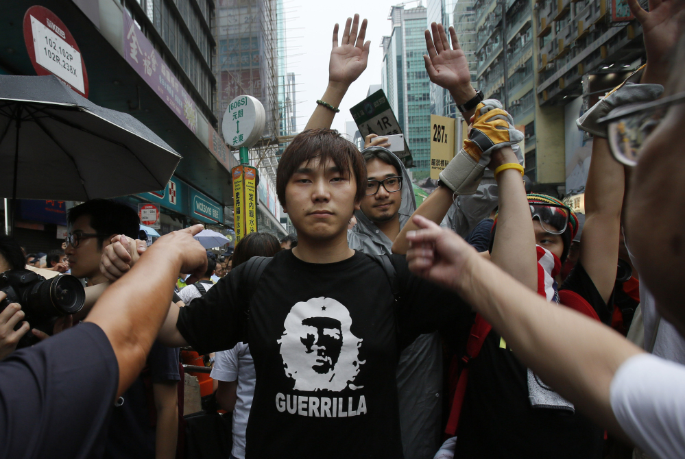 A pro-democracy student protester stands firm as he is insulted by local residents in Mong Kok, Hong Kong, Saturday.