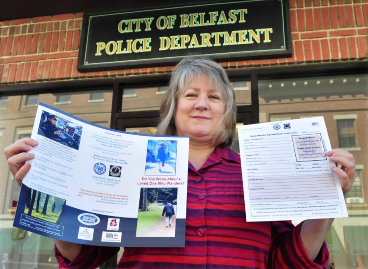 Belfast mother Linda Lee holds a brochure and form for The Wanderers Database on Thursday at the Belfast Police Department. Lee came up with the idea of having identifying information available to first responders in the event people with autism become lost. Her son Christian has autism.