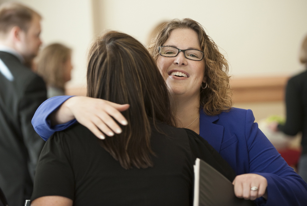 Emily Cain hugs Carin Sychterz, the Bangor Region Chamber of Commerce program coordinator, before a candidate luncheon in September for Fusion Bangor, a business organization, at the Cross Insurance Center in Bangor.