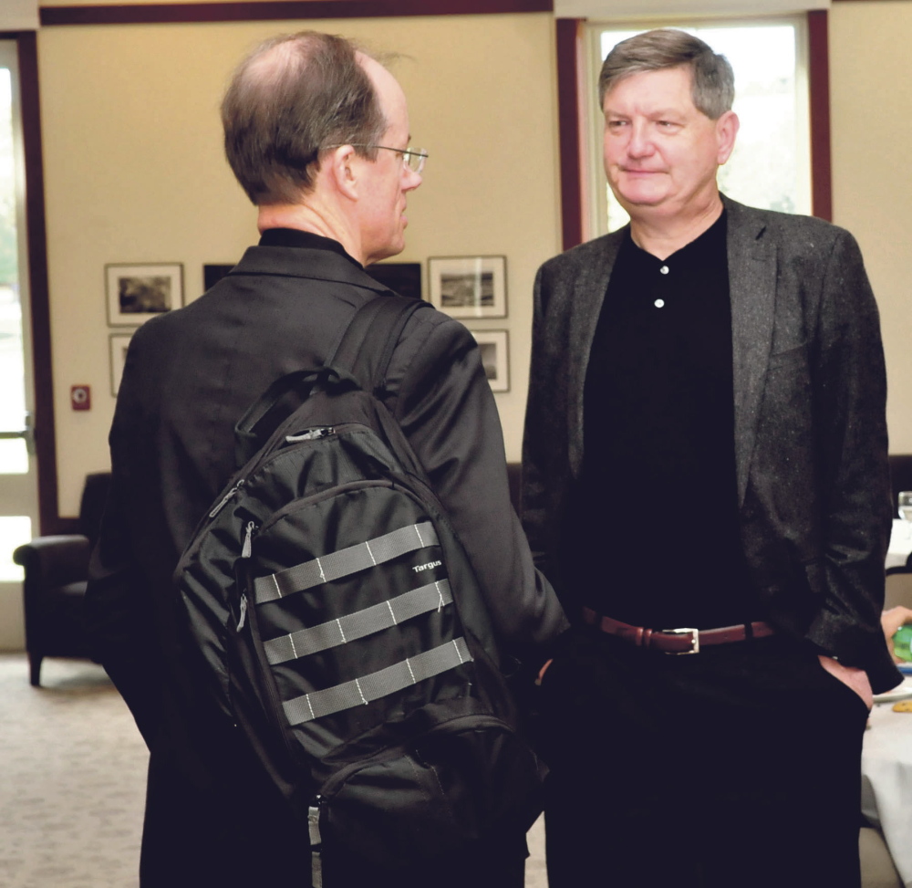 New York Times investigative reporter James Risen, right, speaks with former senior executive of the U.S. National Security Agency and whistleblower Thomas Drake at a journalism conference at Colby College in Waterville on Sunday. Risen was awarded the annual Elijah Parish Lovejoy award for journalism Sunday.