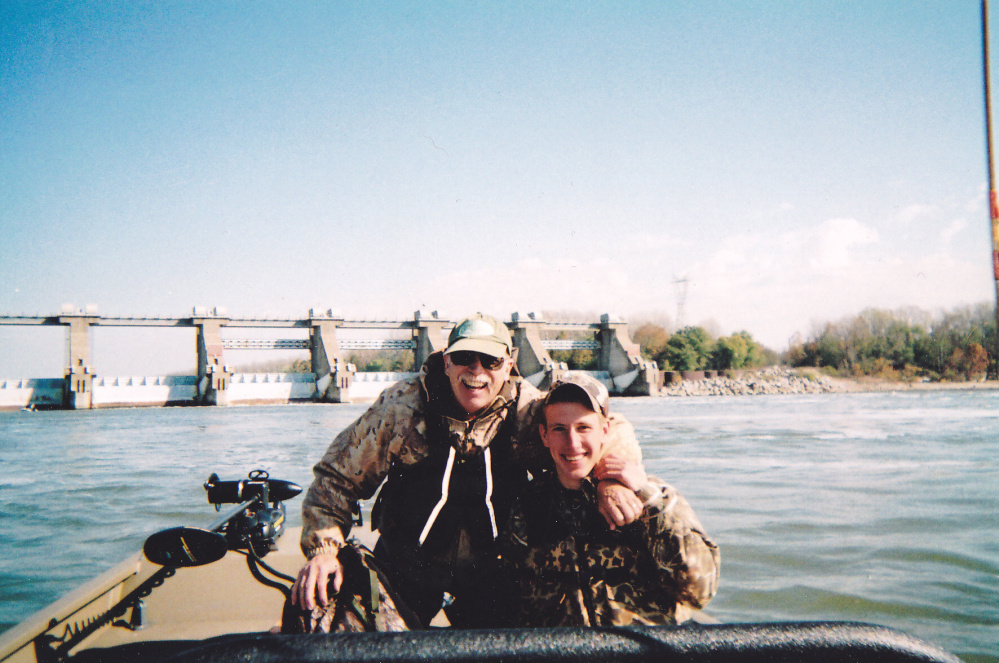 This 2011 photo provided by the Kassig Family, Abdul-Rahman Kassig, right, poses for a photo while fishing with his father, Ed Kassig, near the Cannelton Dam on the Ohio River in southern Indiana.