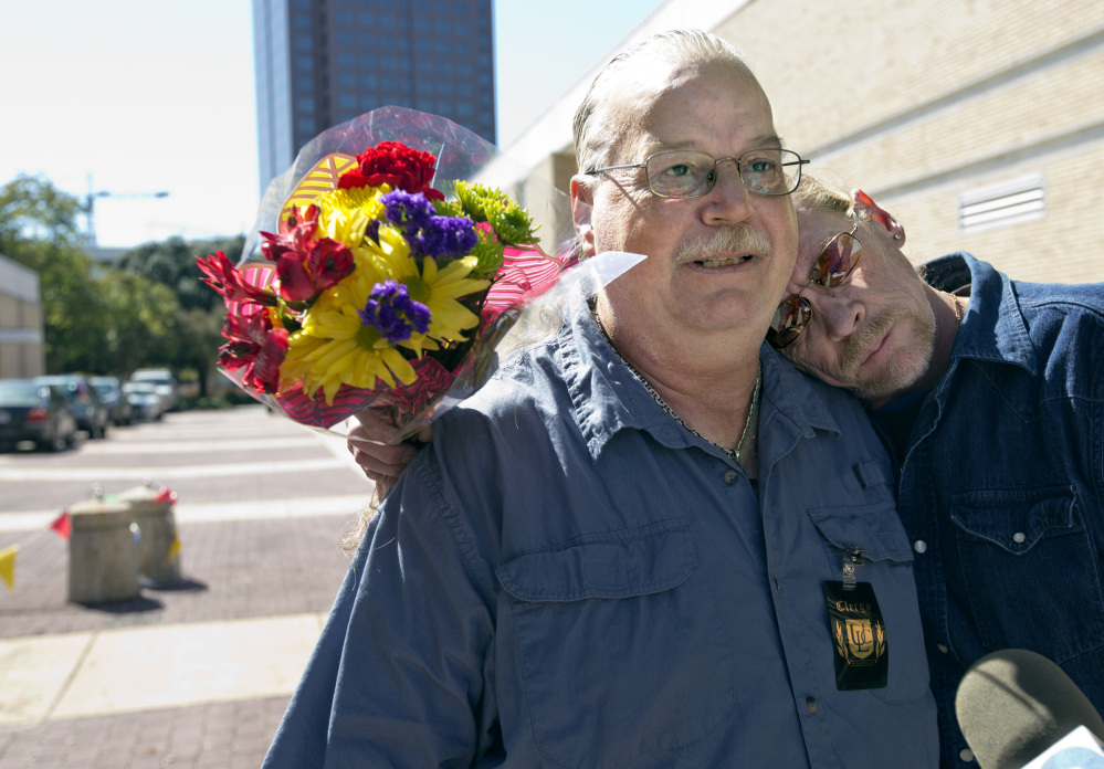 Donald Durst, right, leans on his partner as the two enter the Norfolk Circuit Court to legalize their marriage license on Monday in Norfolk, Va. Same-sex marriages began in Virginia on Monday after the U.S. Supreme Court refused to hear an appeal of a lower-court decision striking down the state’s ban on such unions.