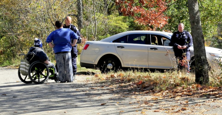 Two Maine State Police investigators interview people outside 354 Rutland Road in Plymouth near where the body of a person was found on the road Monday morning.