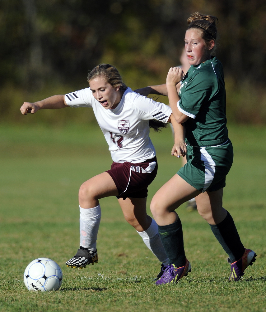 Monmouth’s Sydney Wilson gets past Carrabec’s Bailey Dunphy during a Mountain Valley Conference game Monday in Monmouth. The Mustangs cruised to a 7-0 victory.