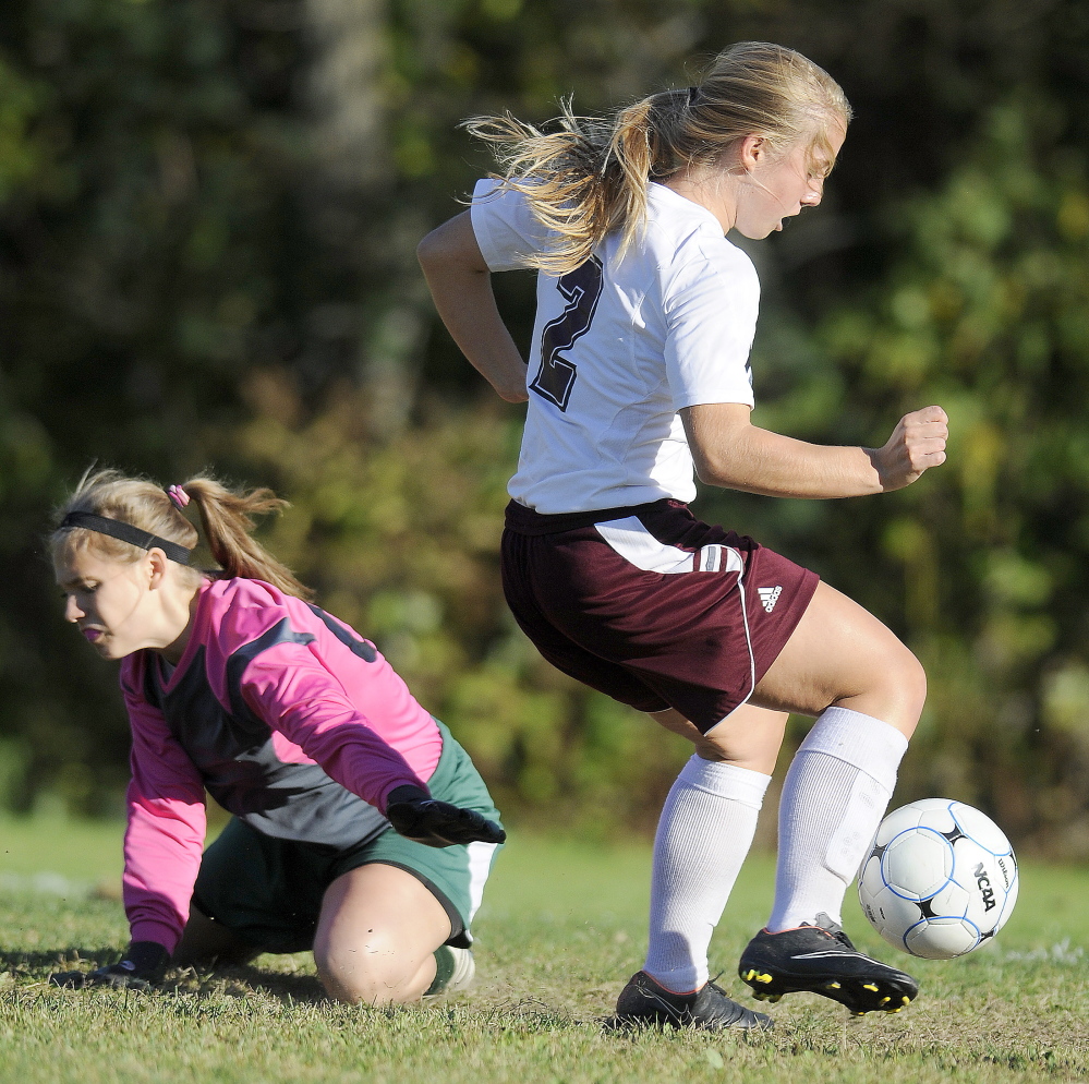 Monmouth Academy’s Haley Fletcher drives Monday past Carrabec’s Stephanie Cassaboom during a Mountain Valley Conference soccer game Monday in Monmouth. The Mustangs won 7-0.