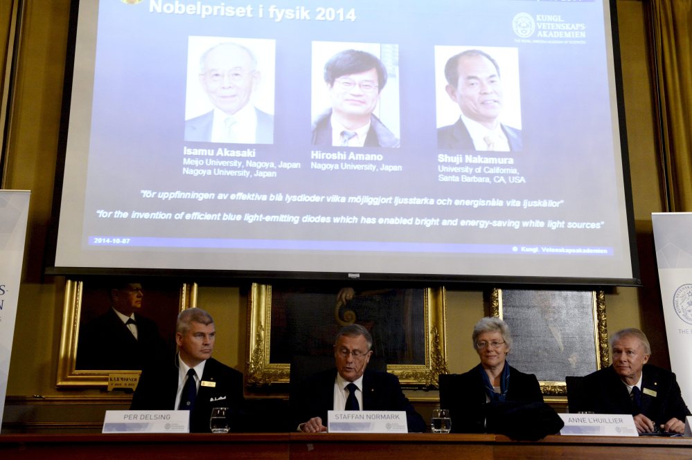 Per Delsing, left, Staffan Nordmark, centre left,  Anne L´Huillier, and  Olle Inganas announce the Nobel prize  laureates in physics at the Royal Swedish Academy of Science in Stockholm, Tuesday.