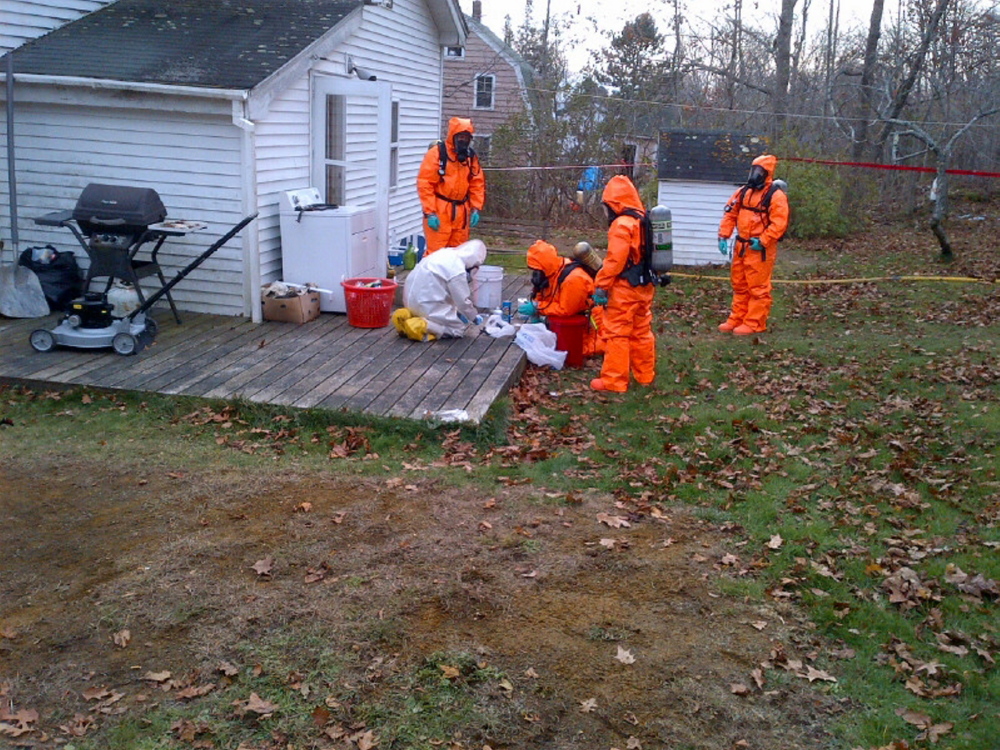 Members of the state’s Clandestine Drug Laboratory Enforcement Team dismantle and seize evidence at an Owls Head home in November 2013.