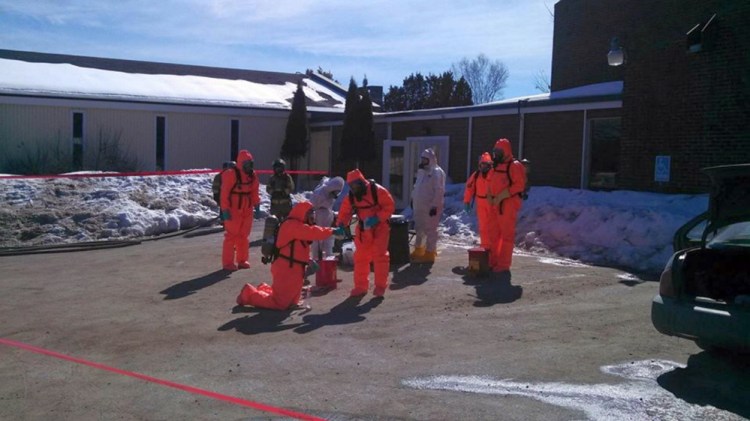 Drug agents wear protective suits in March as they search for methamphetamine outside the Waterville Fireside Inn & Suites on Main Street in Waterville.
