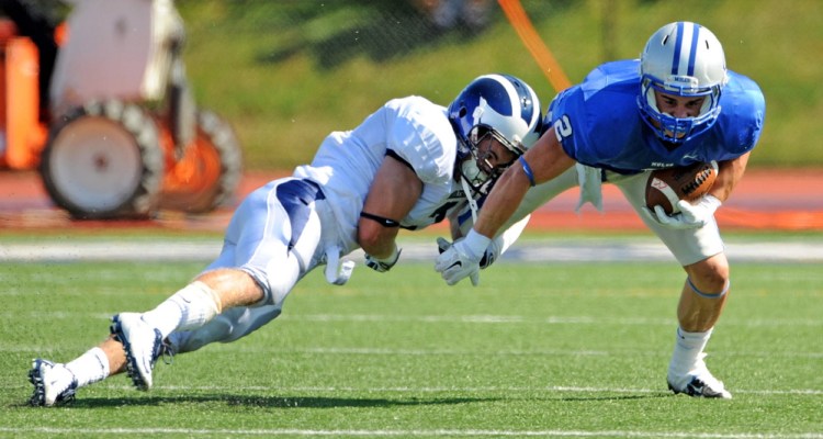 Augusta native and Colby College utility player Luke Duncklee tries to break free from a Middlebury defender during a game Sept. 27 in Waterville.