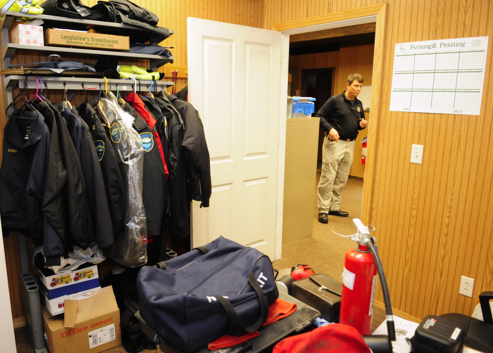 Framed in the interview room door, Monmouth Police Chief Kevin Mulherin gives a tour of the department’s current rented office space that is also used for storage. The interview room doubles as storage space for uniforms and other gear.