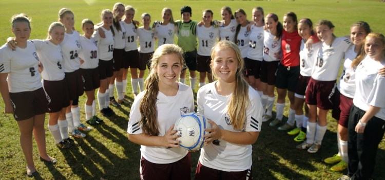 Monmouth Academy’s Sydney Wilson, left, and Haley Fletcher have helped lead their soccer team to an undefeated season.
